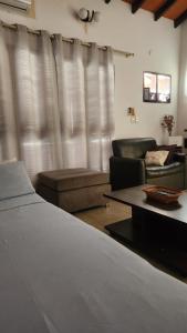 a living room with a bed and a couch at Sala en Casa Familiar para 2 personas in Asuncion