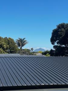 a roof of a building with palm trees in the background at Mount Breeze in Mount Maunganui
