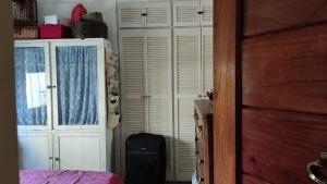 a bedroom with a bed and a closet and a window at Encantador estudio en Chacaito- Excelente ubicación in Caracas