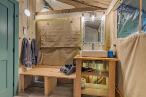 a bathroom with a sink and a mirror at Nature Retreat Cozy tentHVACSpa Bath in Newport +72 photos