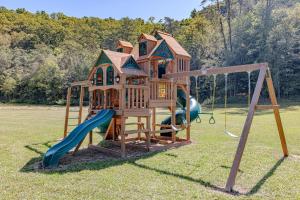 a playground with a tree house and a slide at Nature Retreat Cozy tentHVACSpa Bath in Newport