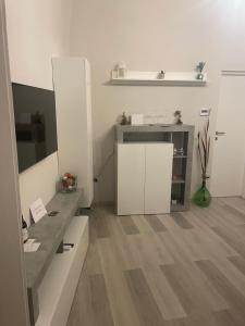 a kitchen with white cabinets and a wooden floor at Ad un Passo dal Duomo in Bovino +31 photos