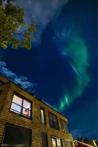 a building with the green lights in the sky at Modern Apartment in Tromsø Center in Tromsø