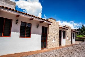 a white house with windows on a street at Cielito Lindo Hotel Boutique 
