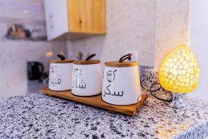 a group of four coffee cups sitting on a counter at Christmas Arabic Escape Roof Terrace 3 Bedroom Luxury Appartment Superb Location and just 15 mins from El Gouna in Hurghada +15 photos