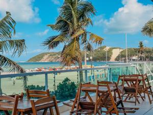 a balcony with chairs and a view of the beach at Ponta Negra Beach Praiano Flat in Natal