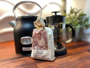 a tea bag sitting on a table next to a tea kettle at Topaz Classy, Cozy Condo Near Beaches & Airport in Crown Point