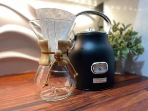a tea kettle and a vase on a table at Topaz Classy, Cozy Condo Near Beaches & Airport in Crown Point