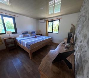 Ένα ή περισσότερα κρεβάτια σε δωμάτιο στο Rangiroa Te Manuia Lodge