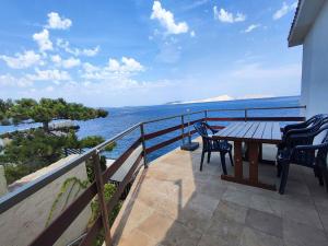 a balcony with a table and chairs and the ocean at Apartment Starigrad - Senj 1 in Starigrad