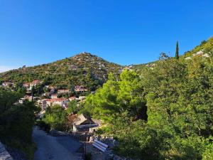 a small town on a hill with a mountain at Apartment Starigrad - Senj 1 in Starigrad