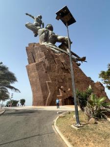 a statue of two people on a rock at Petit palais in Dakar