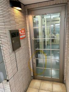 a door with a phone on the side of a building at ハイクレスト中野101 in Tokyo