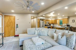 a living room with a couch and a kitchen at 9 Mi to Hickory Ski Center Wooded Warrensburg Gem in Bolton