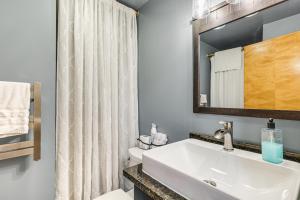 a bathroom with a sink and a mirror at 9 Mi to Hickory Ski Center Wooded Warrensburg Gem in Bolton +22 photos