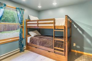 a bedroom with two bunk beds and a window at 9 Mi to Hickory Ski Center Wooded Warrensburg Gem in Bolton