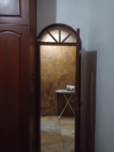a door leading into a room with a stone wall at Casa Paraense in Belém