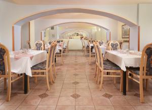 a dining room with tables and chairs and an archway at City Club Prague in Prague