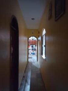 a hallway of a house with an open door at Casa Paraense in Belém +2 photos