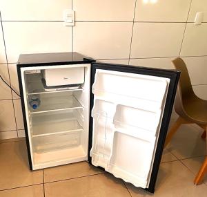 an empty refrigerator with its door open in a room at Casa 03 - Casa com 2 quartos, localizada próximo a rodoviária e aeroporto in Palmas +12 photos
