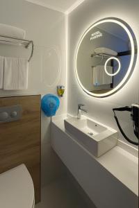 a bathroom with a white sink and a mirror at Positive Hotel in Arnavutköy +21 photos