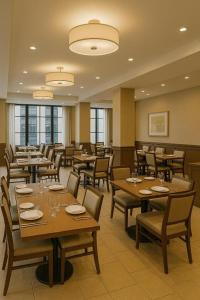 a dining room with wooden tables and chairs at The Grand Sanken Hotel in Kalodran