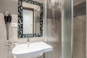 un baño con lavabo y espejo en Imperial Suite Guest House, en Roma