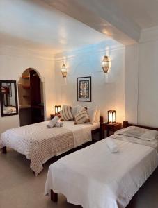 アライアル・ダジュダにあるNa Casa 11 - Pousadaのベッドルーム1室(ベッド2台、照明2つ付)