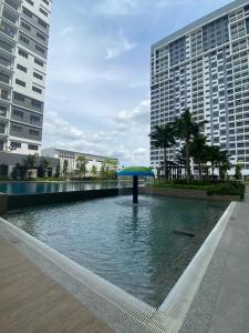 a blue umbrella in the middle of a pond with buildings at Traders park Balakong 3 room Wi-Fi balcony unblock view in Cheras