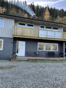 a house with a deck on top of it at Leilighet i Sør-Fron kommune in Sør-Fron