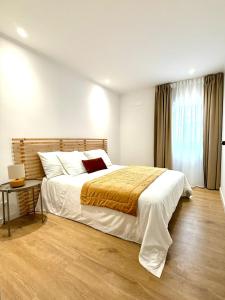 a bedroom with a large bed and a table at Casa da Vila Messines in São Bartolomeu de Messines +23 photos