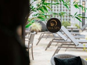 a sign that says thira spa in front of chairs at Grand Mercure Sao Paulo Ibirapuera in Sao Paulo
