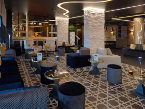 a lobby with couches and chairs and tables at Mercure Orléans Centre Bords de Loire in Orléans