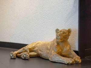 a statue of a cat laying on a table at Mercure Orléans Centre Bords de Loire in Orléans