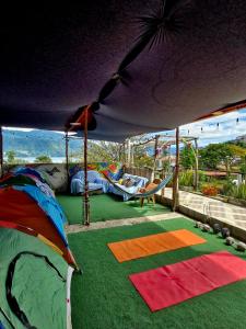 a playground with a play mat and a swing set at Atitlán Backpackers by Don Pascual in San Pedro La Laguna