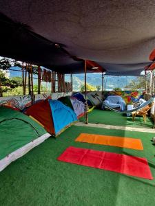 a group of tents on the ground with a rug at Atitlán Backpackers by Don Pascual in San Pedro La Laguna