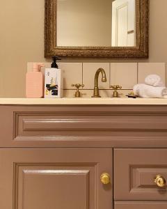 a bathroom vanity with a mirror and a sink at Grand Old Duke in Hobart