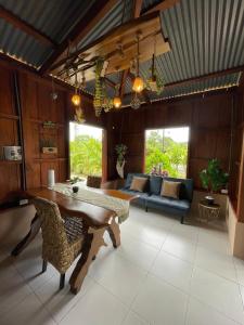a living room with a table and a couch at Ceiba Eco Container in Agua Azul