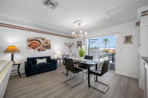 a living room with a dining table and a couch at Carousel Suites -Redington Shores in Redington Shores