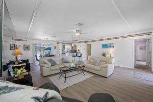 a living room with two couches and a table at Carousel Suites -Redington Shores in Redington Shores