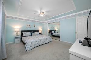 a bedroom with a bed and a ceiling fan at Carousel Suites -Redington Shores in Redington Shores