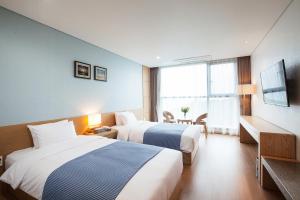 Postel nebo postele na pokoji v ubytování YOUUS Hotel