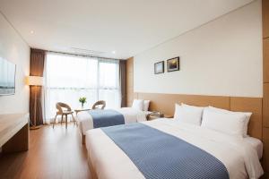 Postel nebo postele na pokoji v ubytování YOUUS Hotel