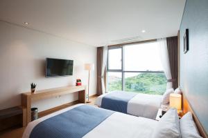 Postel nebo postele na pokoji v ubytování YOUUS Hotel