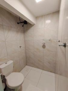 a bathroom with a toilet and a shower at Essenza Suites Natal in Natal