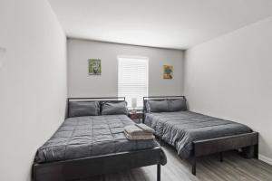 a bedroom with two beds and a window at Modern and Cozy Home in HTX in Houston