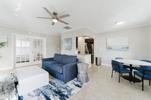 ein Wohnzimmer mit einem blauen Sofa und einem Tisch in der Unterkunft Waterfront Intercoastal, Walk to the Beach, Pool & Hot Tub, Watch the Boats in Boca Raton + 32 Fotos