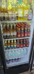 a refrigerator filled with lots of different types of drinks at Bamboo Pool and Lodge in Bocas Town