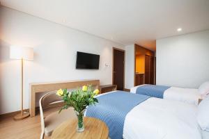 Postel nebo postele na pokoji v ubytování YOUUS Hotel