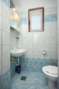 a bathroom with a sink and a toilet at Apartment Pomer 7374a in Pomer +18 photos